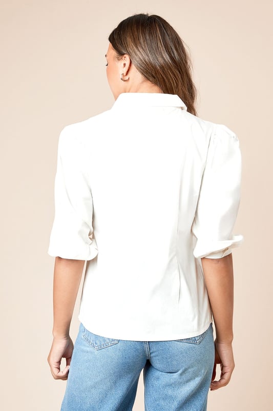 Elegant pintuck detailing along the front creates a refined texture and visual interest
        Classic collared neckline offers a smart, polished finish
        Three-quarter length sleeves with subtle volume for comfortable movement
        Button-through front design for versatile styling options
        Lightweight poplin fabric ensures breathability and comfort for all-day wear
    
    This Dorothy Perkins poplin shirt combines timeless sophistication with contemporary styling. The distinctive pintuck detailing adds subtle texture whilst maintaining a clean, refined aesthetic. Perfect for casual gatherings, style with wide-leg denim trousers and white trainers for a relaxed weekend brunch with friends. For family occasions, pair with tailored trousers and ballet flats for an effortlessly chic ensemble. The versatile design transitions seamlessly from day to evening - simply tuck into a midi skirt and add delicate jewellery for dinner dates. The crisp collared neckline frames the face beautifully, whilst the three-quarter length sleeves offer a flattering silhouette. This wardrobe essential works across seasons, layering comfortably under jumpers in cooler months or standing alone as a sophisticated staple during warmer weather.