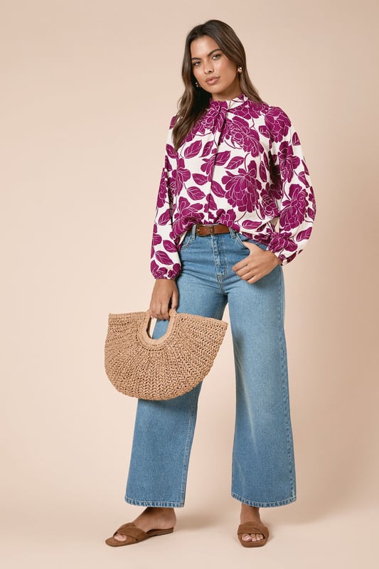 Large Floral Twist Neck Blouse Elegant twist neck detail creates a sophisticated high neckline
Bold floral print makes a striking statement for daytime occasions
Relaxed fit through the body for comfortable all-day wear
Long sleeves with gentle gathering at the cuffs for a feminine silhouette
Lightweight woven fabric drapes beautifully for a flattering fit
This Dorothy Perkins blouse combines eye-catching style with everyday wearability. The distinctive twist neck design offers coverage whilst creating visual interest, perfect for those who prefer not to show too much skin. Style with wide-leg denim and flat sandals for weekend brunches with friends, or pair with tailored trousers and ballet flats for family gatherings. The statement floral pattern works wonderfully with neutral accessories - try a woven handbag and simple gold-toned jewellery to complete your look. For cooler days, layer under a lightweight cardigan or denim jacket without compromising on style. This versatile piece transitions effortlessly from casual coffee dates to baby showers, making it an essential addition to your daywear collection.