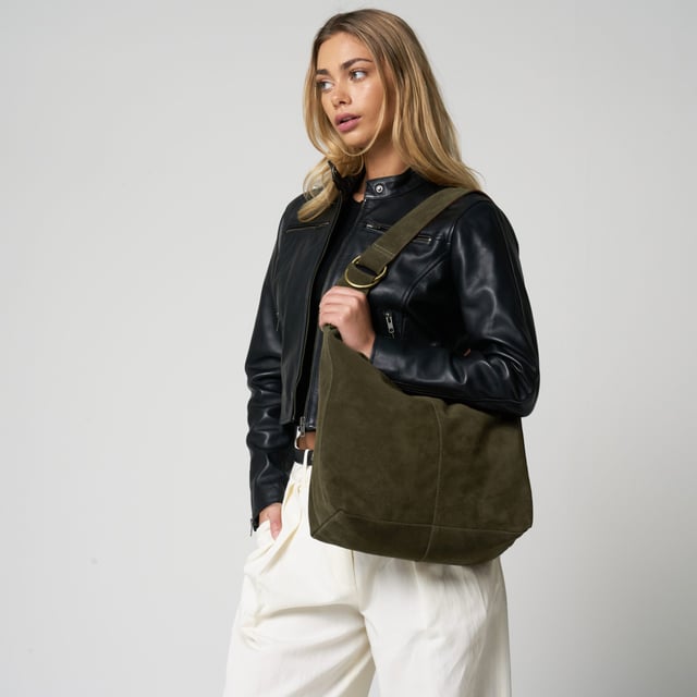 Add effortless elegance to your everyday wardrobe with this beautifully understated suede shoulder bag from Barneys Originals. Crafted from 100% real cow suede, this slouchy silhouette is soft to the touch and perfect for summer styling. 

Designed with practicality in mind, this bag features an adjustable shoulder strap and a roomy interior for all your essentials. The worn-effect gold hardware adds a timeless touch that only gets better with age.

Key Features:

Made from 100% real cow suede

Soft, unstructured shape for a relaxed feel

Adjustable shoulder strap with gold-tone hardware

Magnetic fastening for easy access

Spacious enough for your everyday must-haves

Dimensions:
Height: 10" (25.4 cm)
Width: 15" (38.1 cm)
Handle Drop: 13" (33 cm)