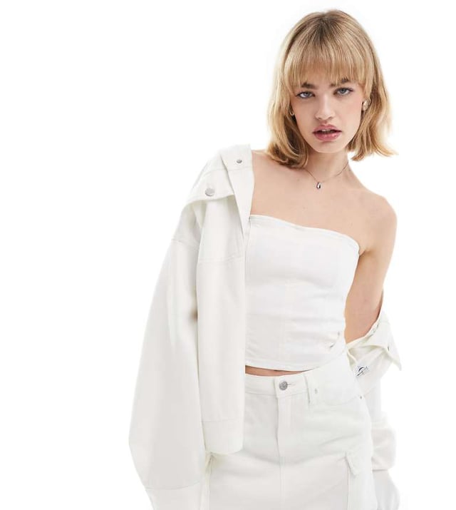 Tops by Calvin Klein Jeans  Skirt and jacket sold separately Bandeau style Logo patch to back Zip fastening Slim fitSold By: Asos