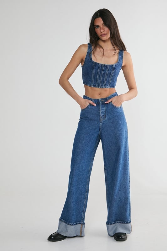 Striking denim corset top with square neckline
        Flattering structured bodice with vertical seam detailing
        Wide shoulder straps for added support and comfort
        Eye-catching lace-up back detail for adjustable fit
        Cropped length perfect for layering or wearing solo
    
    Make a bold statement with this edgy denim corset top from NastyGal. The structured bodice and vertical seaming create a figure-hugging silhouette that flatters your curves, while the square neckline adds a touch of sophistication. The standout feature is the alluring lace-up back, allowing for a customised fit and adding a rebellious flair to your ensemble. Style this versatile piece for casual outings by pairing it with high-waisted wide-leg jeans and trainers for a trendy street-style look. For a night out with friends, team it with a leather mini skirt and ankle boots to amp up the attitude. The cropped length makes it ideal for layering under an oversized blazer or wearing on its own during warmer months. This denim corset top is a must-have addition to any fashion-forward wardrobe, offering endless styling possibilities for various casual occasions.