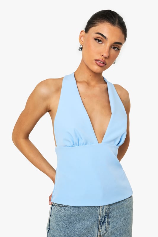 Sleek satin top with striking plunging V-neckline for a bold statement
        Flattering muscle fit design that contours to your silhouette
        Elegant tie-back detail creating an open back for added interest
        Subtle gathering under the bust for a feminine touch
        Versatile sleeveless design perfect for layering or wearing alone
    
    This eye-catching top combines contemporary style with a touch of sophistication. The plunging neckline creates a striking focal point whilst the tie-back detail adds an unexpected twist when you turn around. Style with your favourite denim jeans for casual gatherings or family brunches, as shown on our model. For evening drinks, pair with tailored trousers and statement earrings. The muscle fit silhouette offers a flattering shape that works brilliantly for various body types, whilst the satin fabric catches the light beautifully as you move. This versatile piece transitions effortlessly from day to night - simply switch your trainers for heeled mules and add a clutch bag to transform your look. A wardrobe essential that delivers on both comfort and style for the fashion-forward Boohoo woman.