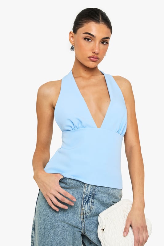Sleek satin top with striking plunging V-neckline for a bold statement
        Flattering muscle fit design that contours to your silhouette
        Elegant tie-back detail creating an open back for added interest
        Subtle gathering under the bust for a feminine touch
        Versatile sleeveless design perfect for layering or wearing alone
    
    This eye-catching top combines contemporary style with a touch of sophistication. The plunging neckline creates a striking focal point whilst the tie-back detail adds an unexpected twist when you turn around. Style with your favourite denim jeans for casual gatherings or family brunches, as shown on our model. For evening drinks, pair with tailored trousers and statement earrings. The muscle fit silhouette offers a flattering shape that works brilliantly for various body types, whilst the satin fabric catches the light beautifully as you move. This versatile piece transitions effortlessly from day to night - simply switch your trainers for heeled mules and add a clutch bag to transform your look. A wardrobe essential that delivers on both comfort and style for the fashion-forward Boohoo woman.
