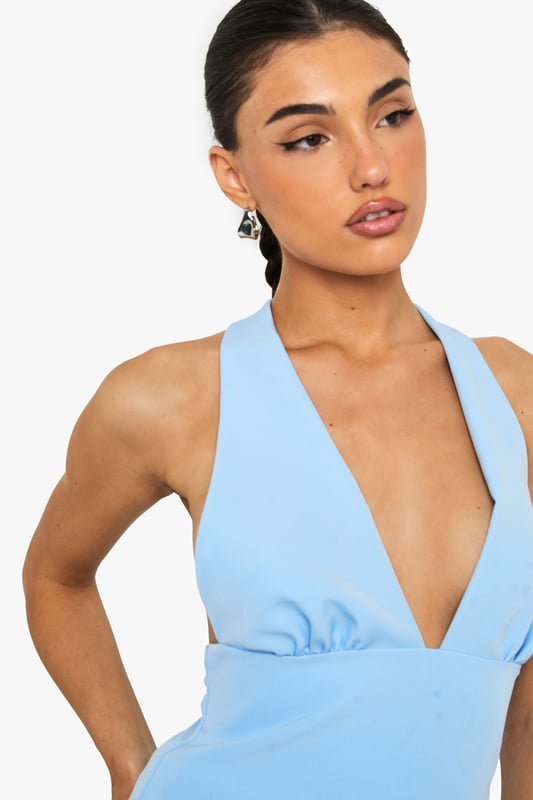 Sleek satin top with striking plunging V-neckline for a bold statement
        Flattering muscle fit design that contours to your silhouette
        Elegant tie-back detail creating an open back for added interest
        Subtle gathering under the bust for a feminine touch
        Versatile sleeveless design perfect for layering or wearing alone
    
    This eye-catching top combines contemporary style with a touch of sophistication. The plunging neckline creates a striking focal point whilst the tie-back detail adds an unexpected twist when you turn around. Style with your favourite denim jeans for casual gatherings or family brunches, as shown on our model. For evening drinks, pair with tailored trousers and statement earrings. The muscle fit silhouette offers a flattering shape that works brilliantly for various body types, whilst the satin fabric catches the light beautifully as you move. This versatile piece transitions effortlessly from day to night - simply switch your trainers for heeled mules and add a clutch bag to transform your look. A wardrobe essential that delivers on both comfort and style for the fashion-forward Boohoo woman.