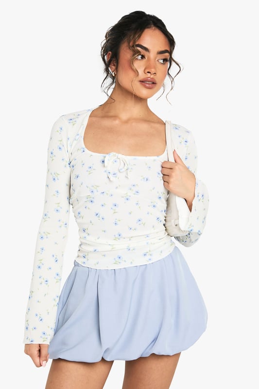 Ribbed jersey top with elegant square neckline for a flattering silhouette
        Distinctive wide sleeves that create a relaxed, contemporary look
        Delicate all-over pattern adds visual interest to this versatile piece
        Subtle ruching detail at the front enhances the feminine design
        Soft, stretchy fabric ensures all-day comfort whilst maintaining shape
    
    This charming patterned top from Boohoo combines comfort with effortless style for your everyday wardrobe. The square neckline frames your dcolletage beautifully, whilst the wide sleeves offer a relaxed fit that's perfect for casual outings. Style with the matching shorts as shown for a coordinated set that's ideal for warm-weather lounging or pair with your favourite denim for coffee dates with the girls. The ribbed jersey fabric provides just the right amount of stretch to hug your curves whilst ensuring freedom of movement. For a complete daytime look, team with white trainers and a mini tote bag, or dress up with ballet flats and layered jewellery for family gatherings. This versatile piece transitions seamlessly from lazy Sunday brunches to casual meetups with friends.