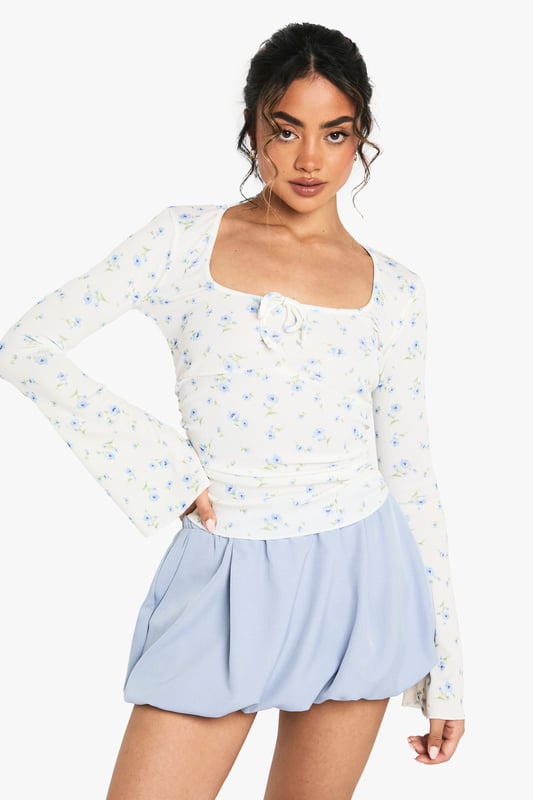 Ribbed jersey top with elegant square neckline for a flattering silhouette
        Distinctive wide sleeves that create a relaxed, contemporary look
        Delicate all-over pattern adds visual interest to this versatile piece
        Subtle ruching detail at the front enhances the feminine design
        Soft, stretchy fabric ensures all-day comfort whilst maintaining shape
    
    This charming patterned top from Boohoo combines comfort with effortless style for your everyday wardrobe. The square neckline frames your dcolletage beautifully, whilst the wide sleeves offer a relaxed fit that's perfect for casual outings. Style with the matching shorts as shown for a coordinated set that's ideal for warm-weather lounging or pair with your favourite denim for coffee dates with the girls. The ribbed jersey fabric provides just the right amount of stretch to hug your curves whilst ensuring freedom of movement. For a complete daytime look, team with white trainers and a mini tote bag, or dress up with ballet flats and layered jewellery for family gatherings. This versatile piece transitions seamlessly from lazy Sunday brunches to casual meetups with friends.