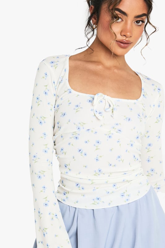 Ribbed jersey top with elegant square neckline for a flattering silhouette
        Distinctive wide sleeves that create a relaxed, contemporary look
        Delicate all-over pattern adds visual interest to this versatile piece
        Subtle ruching detail at the front enhances the feminine design
        Soft, stretchy fabric ensures all-day comfort whilst maintaining shape
    
    This charming patterned top from Boohoo combines comfort with effortless style for your everyday wardrobe. The square neckline frames your dcolletage beautifully, whilst the wide sleeves offer a relaxed fit that's perfect for casual outings. Style with the matching shorts as shown for a coordinated set that's ideal for warm-weather lounging or pair with your favourite denim for coffee dates with the girls. The ribbed jersey fabric provides just the right amount of stretch to hug your curves whilst ensuring freedom of movement. For a complete daytime look, team with white trainers and a mini tote bag, or dress up with ballet flats and layered jewellery for family gatherings. This versatile piece transitions seamlessly from lazy Sunday brunches to casual meetups with friends.