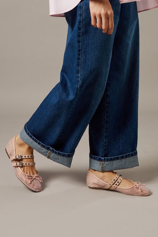 Sheer mesh upper creates a delicate, feminine aesthetic
        Double Mary Jane buckle straps for adjustable fit and distinctive style
        Ballet flat silhouette with comfortable heel height under 2cm
        Decorative studded embellishments add contemporary flair
        Textured pattern detailing for visual interest and dimension
    
    The Faith Giada Ballet Flats reimagine a classic silhouette with modern sensibility. The sheer mesh construction offers breathability whilst the double buckle straps create a secure fit with vintage-inspired charm. These versatile flats can be styled with rolled-up denim jeans for a casual daytime look, as shown by our model, or paired with floaty midi dresses for family gatherings. The subtle studded detailing along the straps adds just the right amount of interest without overwhelming your ensemble. Perfect for city explorations or weekend brunches, these flats provide all-day comfort without sacrificing style. The neutral palette ensures these will become a wardrobe staple that complements virtually any casual outfit. Ideal for those moments when you need something more refined than trainers but desire the same level of comfort.