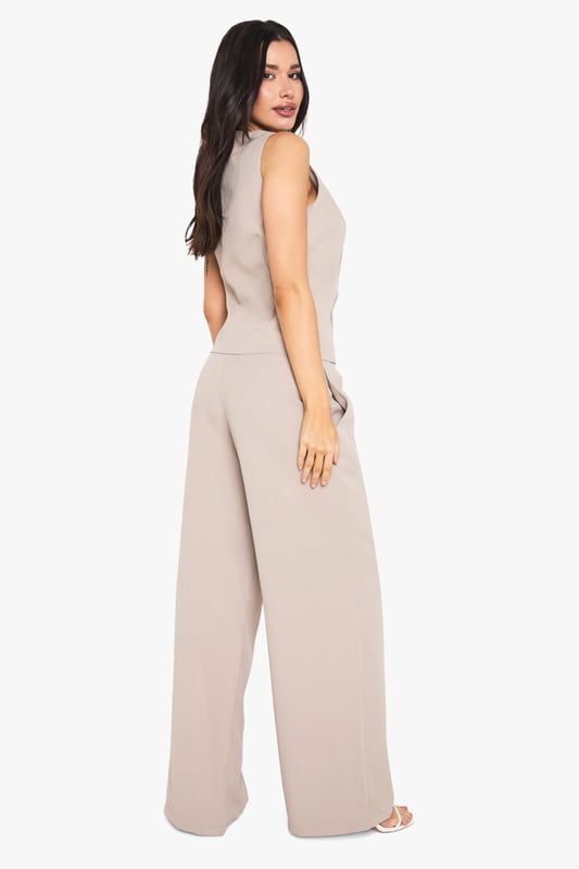 Tall wide leg trousers with elegant front pleats for added dimension and movement
        High-rise waistband with subtle stretch for all-night comfort
        Flowing wide leg silhouette creates a dramatic, fashion-forward profile
        Practical side pockets perfectly positioned for convenience
        Designed specifically for taller frames with extended length for proper fit
    
    Make a statement with these sophisticated wide leg trousers, designed with the taller fashionista in mind. The front pleating adds a touch of tailored refinement whilst the flowing wide leg cut creates a dramatic silhouette that commands attention. Perfect for evening socials, pair with the matching button-front top as shown for a coordinated ensemble that works brilliantly for drinks at upscale venues. For club nights, style with strappy heels and a cropped top to showcase the high waistband. The versatile design transitions effortlessly from casual drinks to more glamorous affairs-simply switch your accessories to match the occasion. These trousers offer the perfect balance of comfort and style for the Boohoo girl who wants to stand out whilst dancing the night away.
