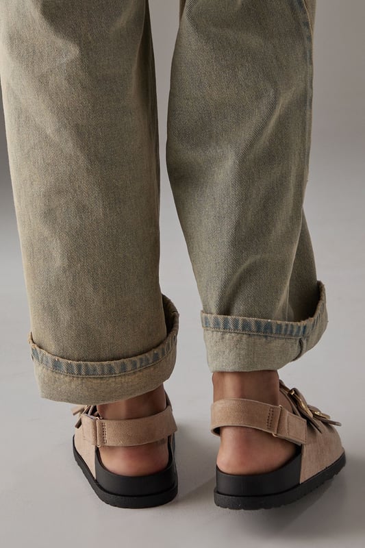 Faux suede slingback sandals featuring distinctive double buckle detailing
        Comfortable footbed design with cushioned insole for all-day wear
        Adjustable slingback strap ensures a secure, customisable fit
        Low heel height of 2.5-4.5cm provides subtle elevation without sacrificing comfort
        Durable synthetic outsole with textured grip for reliable traction
    
    These Reid slingback sandals from Faith blend practicality with contemporary style. The standout double buckle design adds a distinctive touch to these otherwise minimalist footbed sandals, making them a versatile addition to your summer wardrobe. Style them as shown with relaxed trousers and a simple vest top for casual weekend brunches, or pair with a flowing midi dress for garden parties and family gatherings. The adjustable slingback strap ensures these sandals stay securely in place whilst walking, while the cushioned footbed provides essential comfort for long days out. The low heel offers just enough height to flatter without compromising on wearability, making these sandals an ideal choice for city breaks, festival outings or casual summer events where style and comfort are equally important.