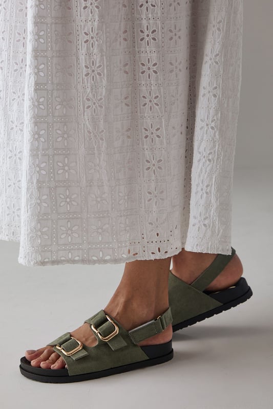Faux suede slingback sandals featuring distinctive double buckle detailing
        Comfortable footbed design with cushioned insole for all-day wear
        Adjustable slingback strap ensures a secure, customisable fit
        Low heel height of 2.5-4.5cm provides subtle elevation without sacrificing comfort
        Durable synthetic outsole with textured grip for reliable traction
    
    These Reid slingback sandals from Faith blend practicality with contemporary style. The standout double buckle design adds a distinctive touch to these otherwise minimalist footbed sandals, making them a versatile addition to your summer wardrobe. Style them as shown with relaxed trousers and a simple vest top for casual weekend brunches, or pair with a flowing midi dress for garden parties and family gatherings. The adjustable slingback strap ensures these sandals stay securely in place whilst walking, while the cushioned footbed provides essential comfort for long days out. The low heel offers just enough height to flatter without compromising on wearability, making these sandals an ideal choice for city breaks, festival outings or casual summer events where style and comfort are equally important.