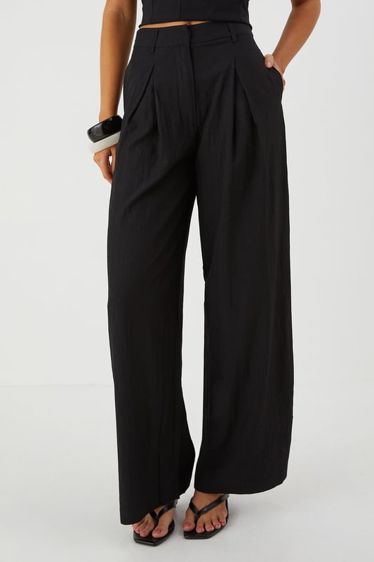 Distinctive crinkle textured fabric adding visual interest and dimension
        Flattering wide leg silhouette that creates a dramatic flowing effect
        Practical side pockets for convenience and functionality
        Front pleating detail that adds structure and sophistication
        High-rise waistband designed to enhance your natural shape
    
    Make a statement with these eye-catching crinkle textured wide leg trousers from MissPap. The dramatic flowing silhouette creates movement with every step whilst the high-rise waistband accentuates your waist for a flattering fit. Style with a fitted crop top as shown for a balanced silhouette that's perfect for casual gatherings. For daytime outings, pair with a simple tee and trainers for an effortlessly cool look. When evening approaches, switch to a bodysuit and strappy heels to transform your ensemble. The versatile design works brilliantly for family gatherings or brunches with friends, whilst the textured fabric adds a distinctive touch that sets these trousers apart from basic styles. The practical side pockets add functionality to this fashion-forward piece that will quickly become a wardrobe favourite.