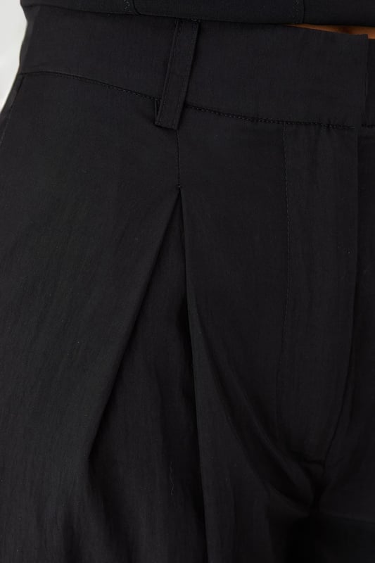 Distinctive crinkle textured fabric adding visual interest and dimension
        Flattering wide leg silhouette that creates a dramatic flowing effect
        Practical side pockets for convenience and functionality
        Front pleating detail that adds structure and sophistication
        High-rise waistband designed to enhance your natural shape
    
    Make a statement with these eye-catching crinkle textured wide leg trousers from MissPap. The dramatic flowing silhouette creates movement with every step whilst the high-rise waistband accentuates your waist for a flattering fit. Style with a fitted crop top as shown for a balanced silhouette that's perfect for casual gatherings. For daytime outings, pair with a simple tee and trainers for an effortlessly cool look. When evening approaches, switch to a bodysuit and strappy heels to transform your ensemble. The versatile design works brilliantly for family gatherings or brunches with friends, whilst the textured fabric adds a distinctive touch that sets these trousers apart from basic styles. The practical side pockets add functionality to this fashion-forward piece that will quickly become a wardrobe favourite.
