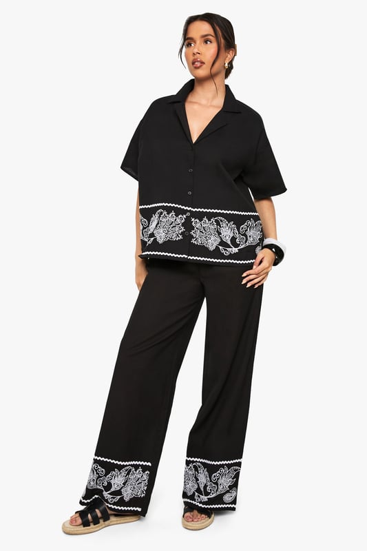 Cotton poplin wide leg trousers featuring striking embroidered border detail
        Relaxed silhouette with comfortable high-rise waistband
        Matching embroidered short-sleeve shirt creates a coordinated set
        Breathable cotton fabric ideal for warm-weather styling
        Versatile wide leg cut that flatters all body shapes
    
    Make a statement in these eye-catching embroidered wide leg trousers from Boohoo. The striking contrast border detailing adds artistic flair to this casual yet sophisticated piece. Crafted from breathable cotton poplin, these trousers offer both comfort and style for your everyday wardrobe. Style them as shown with the matching embroidered shirt for a coordinated look that's perfect for summer gatherings, or pair with a simple vest top and trainers for a more relaxed daytime ensemble. The wide leg silhouette creates a breezy, effortless feel that works brilliantly with flat sandals as pictured. For cooler evenings, layer with a denim jacket and accessorise with a woven bag to complete this contemporary casual look. These trousers transition seamlessly from beach holidays to city breaks, offering versatility for the fashion-forward woman.