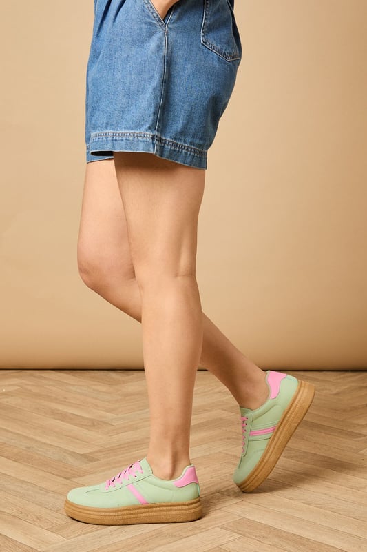 Faux leather platform trainers with eye-catching two-tone design
        Chunky gum sole adds height and distinctive retro appeal
        Contrasting heel tab detail for added visual interest
        Lace-up fastening ensures secure and adjustable fit
        Rounded toe shape offers comfortable everyday wear
    
    The Eudora platform trainers bring playful charm to your casual wardrobe with their distinctive two-tone design. These statement shoes feature a chunky platform sole that adds a subtle lift while maintaining all-day comfort. Style them as shown with relaxed denim jeans and a simple tee for an effortlessly cool weekend look, or pair with a floaty midi dress to create a stylish contrast. The retro-inspired silhouette works brilliantly with wide-leg trousers or cropped styles that showcase the unique design details. Perfect for city exploring, coffee dates or casual shopping trips, these versatile trainers will quickly become your go-to footwear for adding a touch of personality to your everyday ensembles. The lace-up design allows for a customised fit whilst the durable outsole provides reliable traction for your daily adventures.