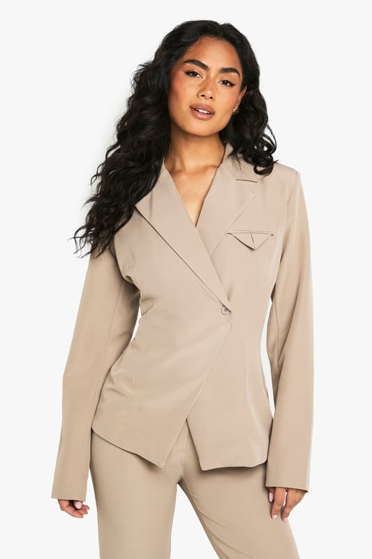 Structured blazer with a contemporary asymmetric design for a fashion-forward silhouette
        Distinctive pocket detail on the chest adds visual interest and practical functionality
        Collared neckline with a sophisticated lapel that creates a polished, tailored appearance
        Regular fit with subtle stretch for comfortable movement throughout your evening
        Clean-lined back with contoured seaming that enhances the feminine shape
    
    Make a striking impression with this structured blazer that effortlessly bridges the gap between smart and statement dressing. The asymmetric front closure and distinctive pocket detail create a contemporary twist on classic tailoring, perfect for commanding attention during your night out. Style with the matching trousers as seen on our model for a coordinated power look, or break the set by pairing with wide-leg trousers and strappy heels. For an evening at the bar, accessorise with statement jewellery and a compact handbag as shown. The versatile design works brilliantly for drinks with colleagues or dancing the night away with friends. The regular fit with added stretch ensures you'll remain comfortable whilst looking utterly composed, no matter how late the night extends.