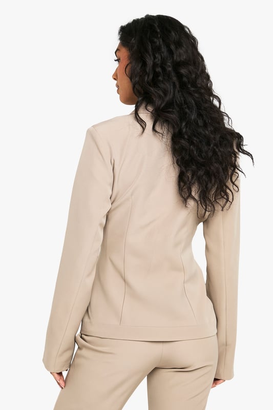 Structured blazer with a contemporary asymmetric design for a fashion-forward silhouette
        Distinctive pocket detail on the chest adds visual interest and practical functionality
        Collared neckline with a sophisticated lapel that creates a polished, tailored appearance
        Regular fit with subtle stretch for comfortable movement throughout your evening
        Clean-lined back with contoured seaming that enhances the feminine shape
    
    Make a striking impression with this structured blazer that effortlessly bridges the gap between smart and statement dressing. The asymmetric front closure and distinctive pocket detail create a contemporary twist on classic tailoring, perfect for commanding attention during your night out. Style with the matching trousers as seen on our model for a coordinated power look, or break the set by pairing with wide-leg trousers and strappy heels. For an evening at the bar, accessorise with statement jewellery and a compact handbag as shown. The versatile design works brilliantly for drinks with colleagues or dancing the night away with friends. The regular fit with added stretch ensures you'll remain comfortable whilst looking utterly composed, no matter how late the night extends.