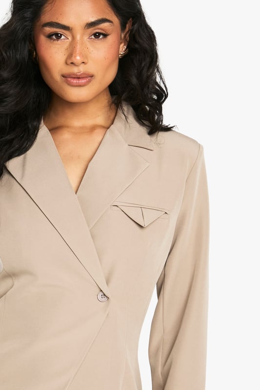 Structured blazer with a contemporary asymmetric design for a fashion-forward silhouette
        Distinctive pocket detail on the chest adds visual interest and practical functionality
        Collared neckline with a sophisticated lapel that creates a polished, tailored appearance
        Regular fit with subtle stretch for comfortable movement throughout your evening
        Clean-lined back with contoured seaming that enhances the feminine shape
    
    Make a striking impression with this structured blazer that effortlessly bridges the gap between smart and statement dressing. The asymmetric front closure and distinctive pocket detail create a contemporary twist on classic tailoring, perfect for commanding attention during your night out. Style with the matching trousers as seen on our model for a coordinated power look, or break the set by pairing with wide-leg trousers and strappy heels. For an evening at the bar, accessorise with statement jewellery and a compact handbag as shown. The versatile design works brilliantly for drinks with colleagues or dancing the night away with friends. The regular fit with added stretch ensures you'll remain comfortable whilst looking utterly composed, no matter how late the night extends.