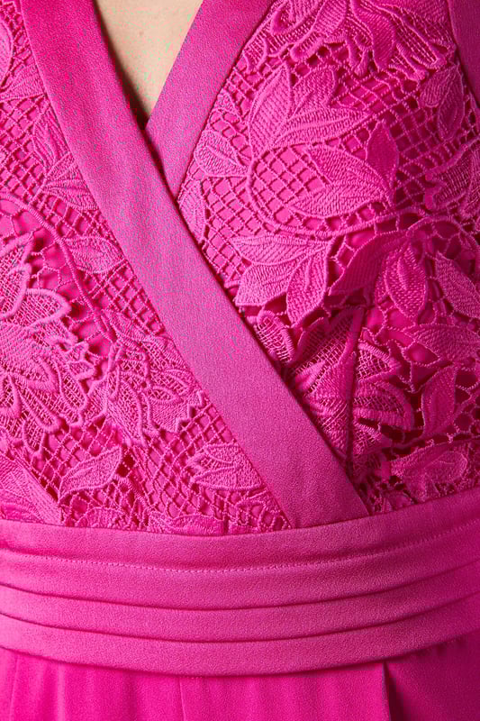 Elegant lace bodice with intricate detailing across the wrap-style V neckline
        Flattering pleated waistband that accentuates the silhouette
        Sleeveless design perfect for sophisticated occasion wear
        Flowing wide-leg trousers that create a graceful movement
        Refined crepe fabric that drapes beautifully for all-day comfort
    
    Make a striking entrance at your next special occasion with this sophisticated Coast jumpsuit. The delicate lace bodice creates a textural contrast against the smooth crepe wide-leg trousers, whilst the wrap-style V neckline frames the dcolletage beautifully. Style as shown with a coordinating fascinator and statement earrings for race day elegance, or pair with metallic heels and a clutch bag for wedding guest perfection. The wide-leg silhouette offers both comfort and a dramatic flair as you move, making this jumpsuit a standout alternative to a traditional dress. For cooler evenings, layer with a tailored blazer or delicate pashmina to maintain the refined aesthetic whilst adding practicality to your ensemble.