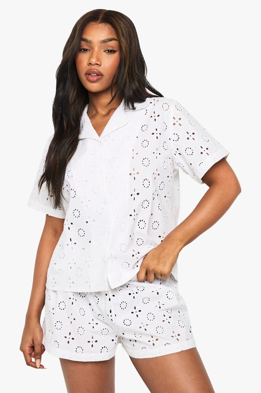 Delicate broderie anglaise pattern throughout both shirt and shorts
        Classic collared shirt design with button-through front
        Relaxed short-sleeve silhouette for comfortable movement
        Matching shorts with comfortable elastic waistband
        Lightweight fabric perfect for warmer nights
    
    Drift into dreamland in style with this charming short-sleeve pyjama set. The intricate broderie anglaise detailing adds a touch of feminine elegance to your nightwear collection, whilst the classic shirt design with collar creates a put-together look even as you unwind. The relaxed fit ensures unrestricted movement throughout the night, whilst the matching shorts complete this coordinated set beautifully. Perfect for summer evenings or those who prefer to stay cool whilst sleeping, this set also makes for a lovely loungewear option for lazy weekend mornings. Pair with your favourite slippers and a lightweight dressing gown for those midnight kitchen trips, or simply enjoy the comfort of this beautiful set on its own as you settle in with a good book before bedtime.