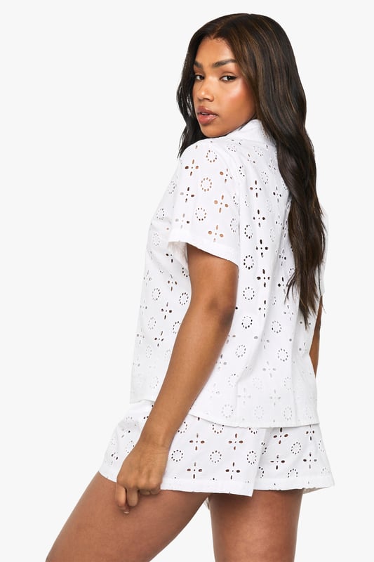 Delicate broderie anglaise pattern throughout both shirt and shorts
        Classic collared shirt design with button-through front
        Relaxed short-sleeve silhouette for comfortable movement
        Matching shorts with comfortable elastic waistband
        Lightweight fabric perfect for warmer nights
    
    Drift into dreamland in style with this charming short-sleeve pyjama set. The intricate broderie anglaise detailing adds a touch of feminine elegance to your nightwear collection, whilst the classic shirt design with collar creates a put-together look even as you unwind. The relaxed fit ensures unrestricted movement throughout the night, whilst the matching shorts complete this coordinated set beautifully. Perfect for summer evenings or those who prefer to stay cool whilst sleeping, this set also makes for a lovely loungewear option for lazy weekend mornings. Pair with your favourite slippers and a lightweight dressing gown for those midnight kitchen trips, or simply enjoy the comfort of this beautiful set on its own as you settle in with a good book before bedtime.