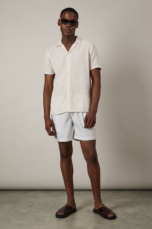 Lightweight woven swim shorts with subtle print detail
        Comfortable elasticated waistband with adjustable drawstring
        Quick-drying fabric perfect for beach and poolside wear
        Relaxed fit design for ease of movement
        Versatile mid-thigh length suitable for swimming and casual wear
    
    These Burton swim shorts combine practicality with understated style for the modern man. The subtle print adds visual interest without being overly bold, making them an excellent choice for various summer settings. Pair with a crisp linen shirt as shown for a sophisticated beach club look, or team with a plain t-shirt for casual beachside drinks. The versatile design transitions effortlessly from swimming to socialising, making them ideal for holiday packing. Perfect for family barbecues, coastal walks or simply lounging by the pool with a cold drink. These shorts reflect the practical sensibility that Burton is known for - comfortable enough for all-day wear yet smart enough to take you from daytime activities to evening gatherings at the local pub with friends. Add sandals and sunglasses to complete your relaxed summer ensemble.