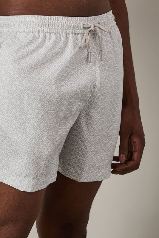 Lightweight woven swim shorts with subtle print detail
        Comfortable elasticated waistband with adjustable drawstring
        Quick-drying fabric perfect for beach and poolside wear
        Relaxed fit design for ease of movement
        Versatile mid-thigh length suitable for swimming and casual wear
    
    These Burton swim shorts combine practicality with understated style for the modern man. The subtle print adds visual interest without being overly bold, making them an excellent choice for various summer settings. Pair with a crisp linen shirt as shown for a sophisticated beach club look, or team with a plain t-shirt for casual beachside drinks. The versatile design transitions effortlessly from swimming to socialising, making them ideal for holiday packing. Perfect for family barbecues, coastal walks or simply lounging by the pool with a cold drink. These shorts reflect the practical sensibility that Burton is known for - comfortable enough for all-day wear yet smart enough to take you from daytime activities to evening gatherings at the local pub with friends. Add sandals and sunglasses to complete your relaxed summer ensemble.