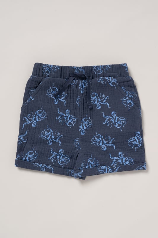 This outfit set from Lily and Jack includes a muslin shirt, shorts, and a bucket hat, all featuring a fun all-over print. Light, breathable, and stylish, this set is perfect for keeping your little one cool and cute on sunny days, with a coordinated look for effortless dressing.