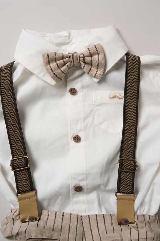 Dress your little one to impress with this delightful set from Little Gent. Featuring a shirt, bowtie, and shorts with attached braces. Perfect for special occasions or stylish outings, your little one will look effortlessly dapper and be ready to steal the spotlight!