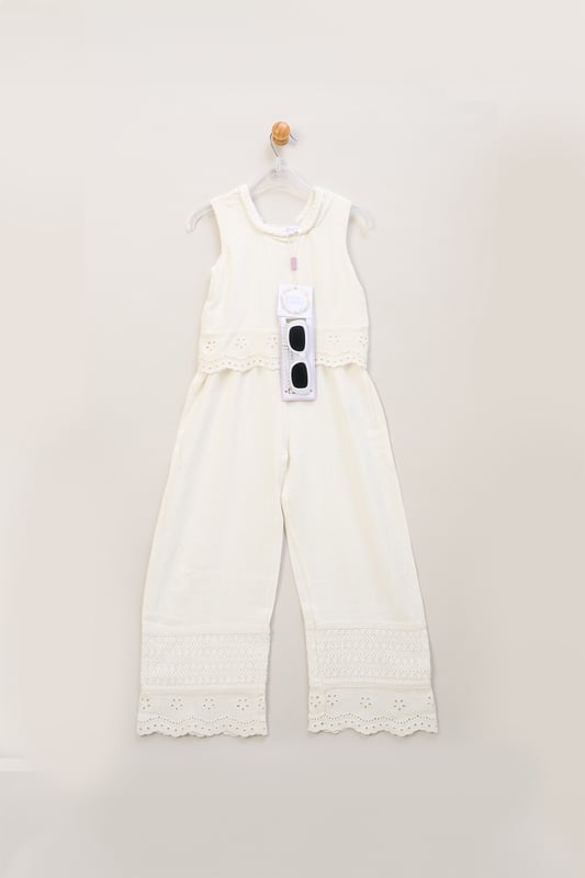 Perfect for holidays and summertime events, this adorable broderie jumpsuit by Miss features a playful scalloped edge design and crotchet panel. The set comes with matching sunglasses, creating a fun and stylish outfit that's both comfortable and versatile for sunny days.