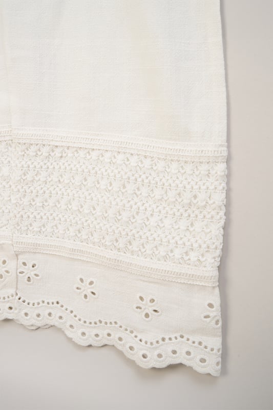 Perfect for holidays and summertime events, this adorable broderie jumpsuit by Miss features a playful scalloped edge design and crotchet panel. The set comes with matching sunglasses, creating a fun and stylish outfit that's both comfortable and versatile for sunny days.
