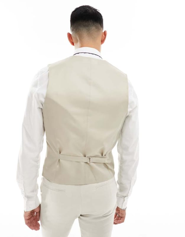 Suits by ASOS DESIGN Do the smart thing V-neck Button placket Pocket details Contrast back with an adjustable cinch Skinny fitSold By: Asos