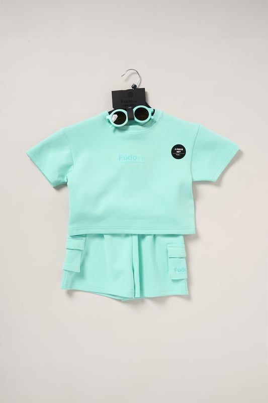 Keep your little one on trend this season with this 3-piece outfit set from Fudo. The set includes a heavyweight oversized T-shirt with a tonal chest logo, matching shorts with two large side pockets and a drawstring waist, plus stylish sunglasses. A comfy, trendy set that blends fashion and function for your little one’s wardrobe.