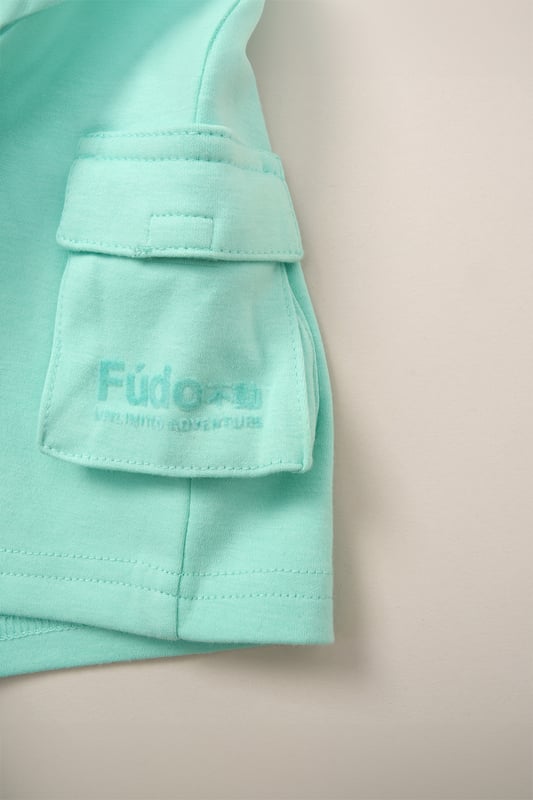 Keep your little one on trend this season with this 3-piece outfit set from Fudo. The set includes a heavyweight oversized T-shirt with a tonal chest logo, matching shorts with two large side pockets and a drawstring waist, plus stylish sunglasses. A comfy, trendy set that blends fashion and function for your little one’s wardrobe.
