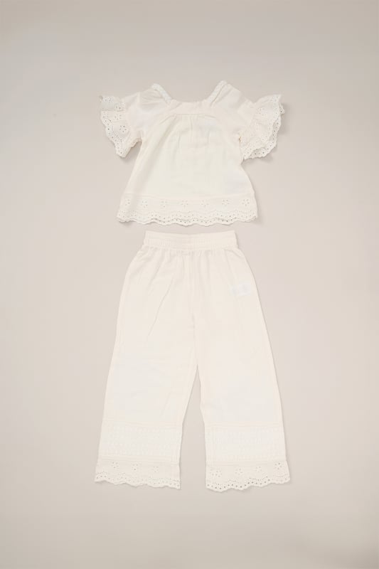 This co-ord set by Miss is a stylish blend of comfort and style. The top features floaty sleeves, while the wide-leg trousers bring effortless elegance. Both pieces are adorned with broderie and crochet panel detailing, making it a perfect choice for sunny days and special outings.