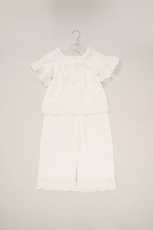 This co-ord set by Miss is a stylish blend of comfort and style. The top features floaty sleeves, while the wide-leg trousers bring effortless elegance. Both pieces are adorned with broderie and crochet panel detailing, making it a perfect choice for sunny days and special outings.