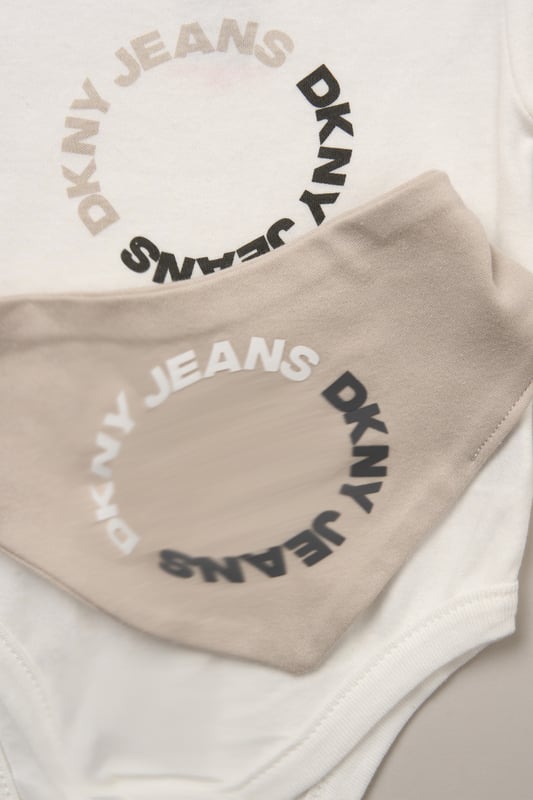 Designed for sunny days and busy babies, this 3-piece set from DKNY includes a cotton bodysuit, comfy shorts and a coordinating bib. A great go-to for playdates and mealtimes, it offers soft comfort and cute style in one. 100% cotton.
