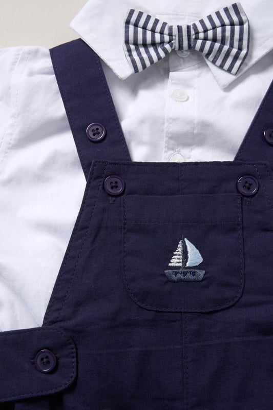 Dress your little one in style with this adorable bodysuit shirt and dungarees set by Little Gent. Complete with a charming bowtie, this outfit is perfect for any occasion. Designed with playful charm and practicality in mind, it’s an ideal choice to keep your little one looking dapper all day long.