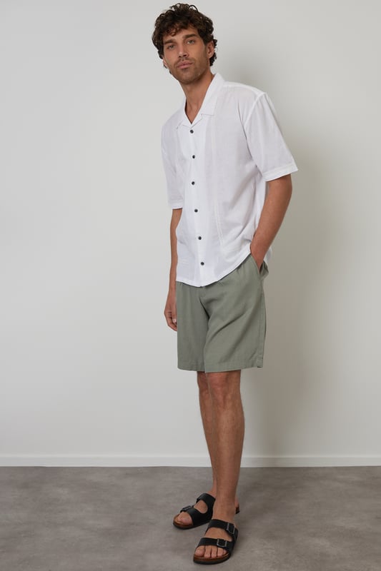 Elevate your holiday wardrobe with this cotton and linen blend short-sleeve shirt from Threadbare. Designed for the modern trendsetter, this relaxed-fit shirt has a revere collar and is made from a lightweight cotton linen blend fabric perfect for the warmer weather. With crochet lace detailing on the trims for an elevated look. Wear with chino shorts and sandals for a relaxed holiday look, or smarten it up with a pair of linen blend trousers.