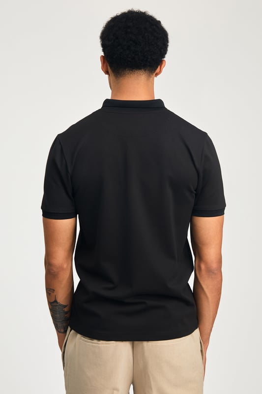 This zip-neck polo shirt from Kensington Eastside blends classic sophistication with modern design. Lightweight and breathable, it’s a versatile choice for smart-casual occasions, ensuring style and comfort effortlessly.