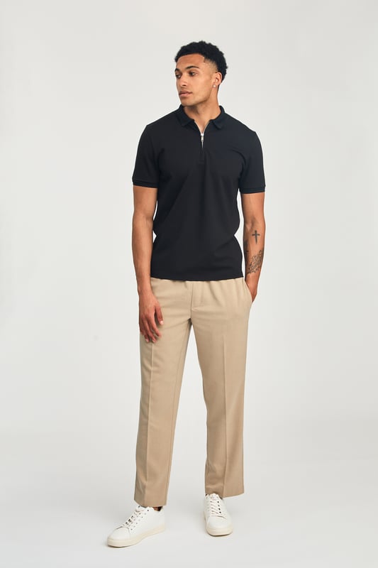 This zip-neck polo shirt from Kensington Eastside blends classic sophistication with modern design. Lightweight and breathable, it’s a versatile choice for smart-casual occasions, ensuring style and comfort effortlessly.