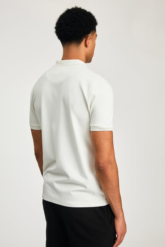 This zip-neck polo shirt from Kensington Eastside blends classic sophistication with modern design. Lightweight and breathable, it’s a versatile choice for smart-casual occasions, ensuring style and comfort effortlessly.