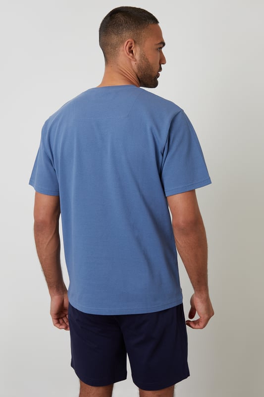 Experience ultimate comfort with this short pyjama set from Threadbare, designed for restful nights and easy lounging. Cut in a regular fit, this pyjama set is perfect for year round comfort. This set includes a short sleeve popcorn textured crew neck top with Threadbare embroidery on the chest and cotton shorts with an elasticated waistband, drawcords and two side pockets. Ideal for lounging or sleeping, this set is a must-have for your nightwear collection.