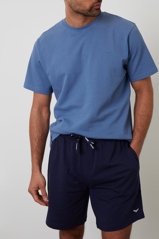 Experience ultimate comfort with this short pyjama set from Threadbare, designed for restful nights and easy lounging. Cut in a regular fit, this pyjama set is perfect for year round comfort. This set includes a short sleeve popcorn textured crew neck top with Threadbare embroidery on the chest and cotton shorts with an elasticated waistband, drawcords and two side pockets. Ideal for lounging or sleeping, this set is a must-have for your nightwear collection.