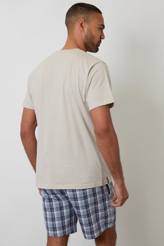 Unwind in comfort with this pyjama set from Threadbare, designed for a relaxed and effortless sleep. Cut in a regular fit, this pyjama set is perfect for year round comfort. This set includes a short sleeve crew neck top with Threadbare embroidery on the chest and checked cotton poplin lounge shorts with an elasticated waistband, drawcords and two side pockets. Ideal for lounging or sleeping, this set is a must-have for your nightwear collection.