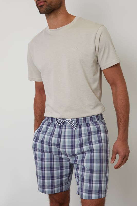 Unwind in comfort with this pyjama set from Threadbare, designed for a relaxed and effortless sleep. Cut in a regular fit, this pyjama set is perfect for year round comfort. This set includes a short sleeve crew neck top with Threadbare embroidery on the chest and checked cotton poplin lounge shorts with an elasticated waistband, drawcords and two side pockets. Ideal for lounging or sleeping, this set is a must-have for your nightwear collection.