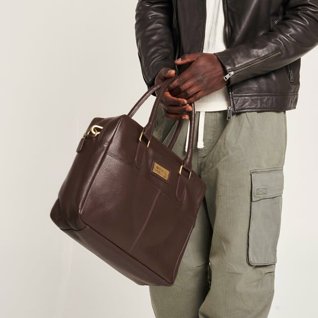 – Real leather
– Detachable shoulder strap
– Two zipped compartments
– Velcro laptop sleeve
– 14″ x 12″ x 4.5″

Commute in style with this brown leather messenger bag from Barneys Originals. Made from durable real leather, this sleek everyday essential is perfect for carrying your tech, with a padded Velcro laptop sleeve and handy inner zip pocket.

With two zipped sections to keep things organised, you can switch between the top handles and detachable shoulder strap depending on your day. Whether you’re heading to the office or a café, this bag has your back.
