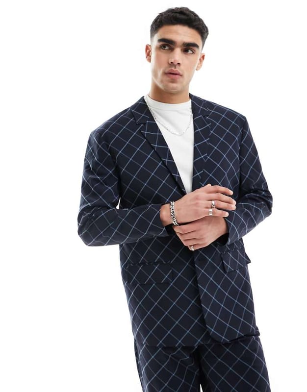 ASOS DESIGN relaxed bias cut check suit jacket in navy windowpane Suits by ASOS DESIGN Suits you Notch lapels Single-breasted style Two-button fastening Pocket details Relaxed fitSold By: Asos