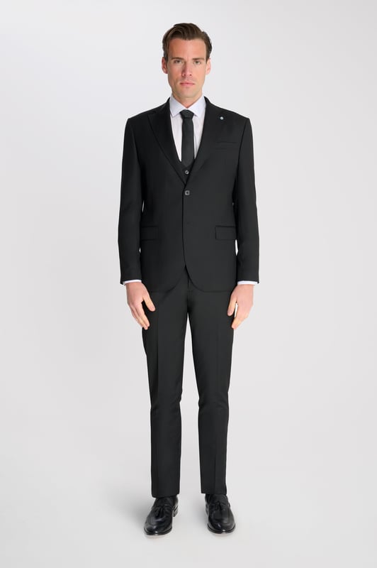 3-Piece Suit Set by Carter & Jones
Elevate your formal wardrobe with the 3-Piece Suit Set by Carter & Jones, designed for the discerning gentleman who values both style and sophistication. This suit set includes a jacket, trousers, and waistcoat, each featuring those classic details that ensure you stand out in any setting.

Jacket: A 2-Button Single Breasted design with a classic cut that exudes modern elegance. The jacket is equipped with two back vents for added comfort and ease of movement. Finished with a distinctive Contrasting Lapel Pin for a touch of personality, the jacket also offers 2 Flap Pockets, a chest pocket, and multiple internal pockets for practicality. Fully lined for a premium finish.

Trousers: Pleated trousers that offer a refined silhouette with a Hook and Bar Closure, combining comfort with style for an impeccable fit.

Waistcoat: A statement piece, featuring a Cinch Belt for a tailored fit, Silken Lining, and a Button Closure for that perfect polished look.

Slim Fit 

Main Fabric 68% Polyester 29% Viscose 3% Elastane.

Lining 100% Polyester.

Dry Clean Only.

This suit comes nested, meaning the trousers will have a 6 inch difference to the jacket (eg.: Jacket & Waistcoat - 38R | Trousers - 32R).

This 3-piece suit set is the ideal choice for weddings, business events, or any occasion that requires a sharp, sophisticated appearance. Carter & Jones delivers exceptional craftsmanship, ensuring you look your best with every wear.