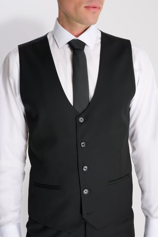 3-Piece Suit Set by Carter & Jones
Elevate your formal wardrobe with the 3-Piece Suit Set by Carter & Jones, designed for the discerning gentleman who values both style and sophistication. This suit set includes a jacket, trousers, and waistcoat, each featuring those classic details that ensure you stand out in any setting.

Jacket: A 2-Button Single Breasted design with a classic cut that exudes modern elegance. The jacket is equipped with two back vents for added comfort and ease of movement. Finished with a distinctive Contrasting Lapel Pin for a touch of personality, the jacket also offers 2 Flap Pockets, a chest pocket, and multiple internal pockets for practicality. Fully lined for a premium finish.

Trousers: Pleated trousers that offer a refined silhouette with a Hook and Bar Closure, combining comfort with style for an impeccable fit.

Waistcoat: A statement piece, featuring a Cinch Belt for a tailored fit, Silken Lining, and a Button Closure for that perfect polished look.

Slim Fit 

Main Fabric 68% Polyester 29% Viscose 3% Elastane.

Lining 100% Polyester.

Dry Clean Only.

This suit comes nested, meaning the trousers will have a 6 inch difference to the jacket (eg.: Jacket & Waistcoat - 38R | Trousers - 32R).

This 3-piece suit set is the ideal choice for weddings, business events, or any occasion that requires a sharp, sophisticated appearance. Carter & Jones delivers exceptional craftsmanship, ensuring you look your best with every wear.